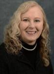 headshot of MaryAnne Lindeblad, woman, with blonde hair wearing black sweater