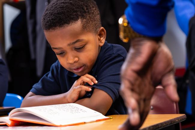 A kindergarten student reads.